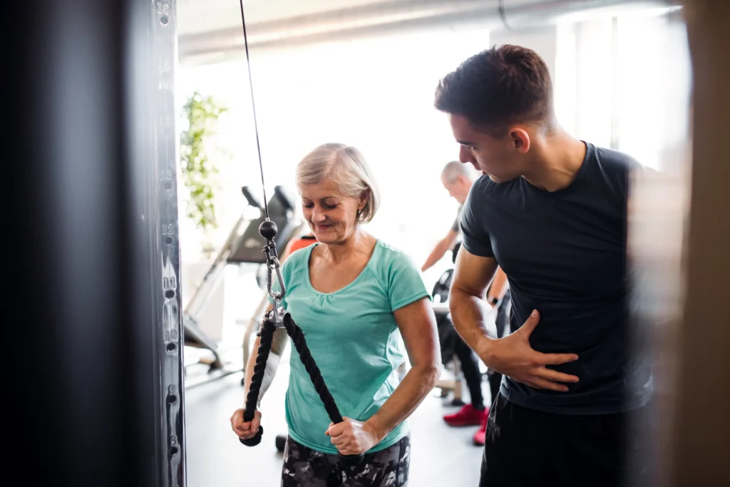 physical therapist leading his patient through a strength exercise