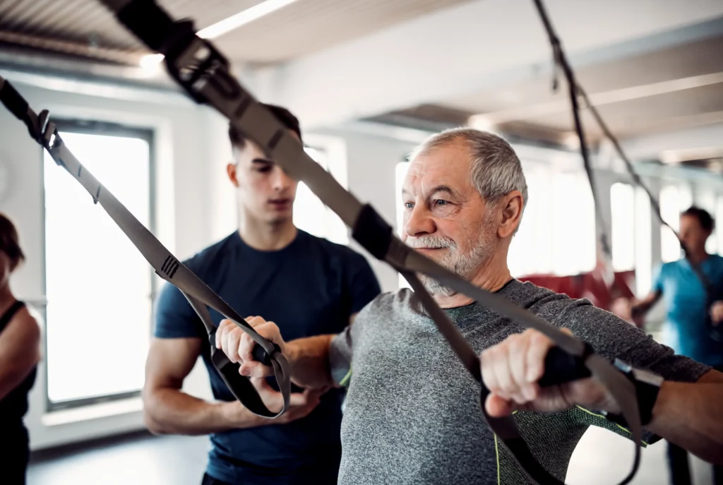 physical therapist coaching his patient through a strength exercise