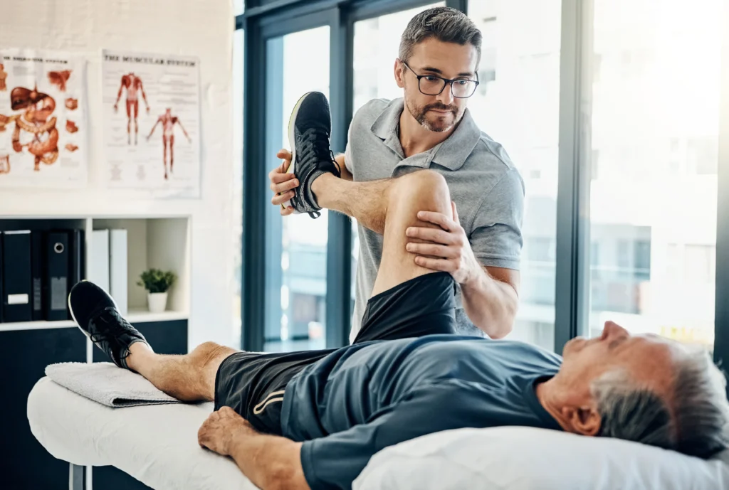 physical therapist stretching his patient's knee to treat unwanted knee pain