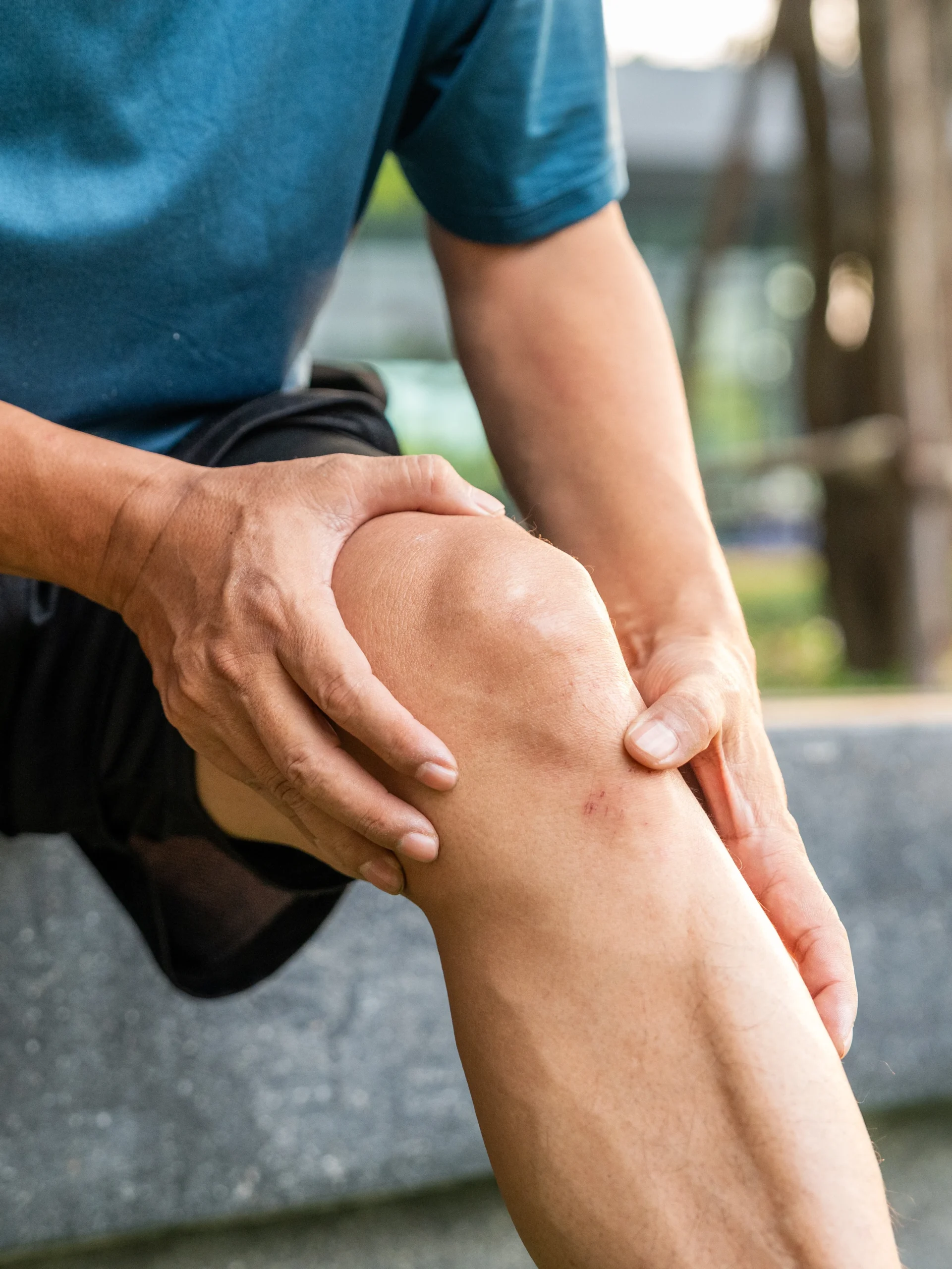 active adult with unwanted knee pain holding his knee when the pain flared up