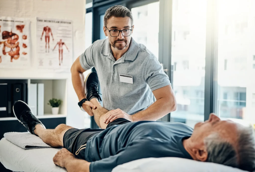 physical therapist examining his patient's knee for unwanted knee pain
