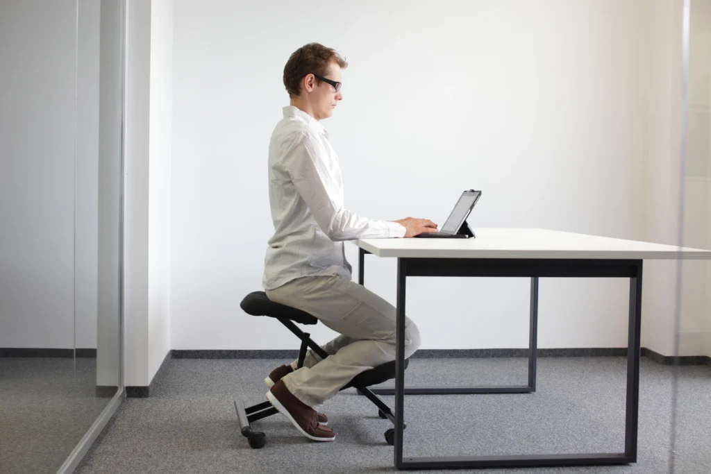 Man in white shirt with good posture at desk